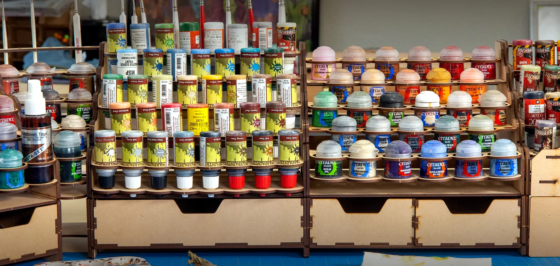Inside the Umer Hardware paint shop — shelves of paint cans and color swatches